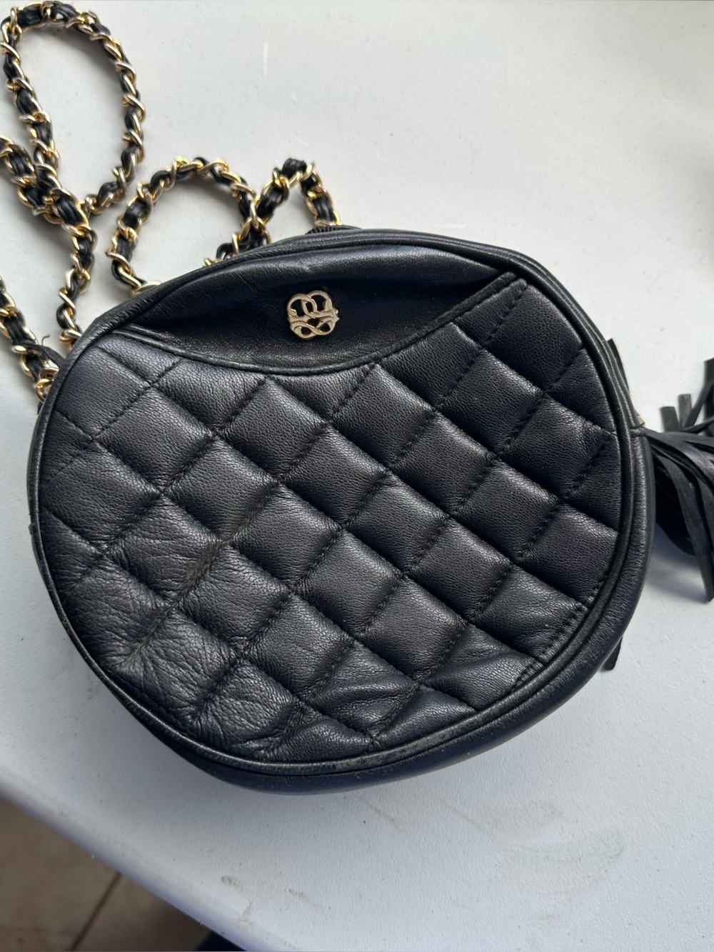 Black Quilted Round Crossbody Bag with Gold Chain